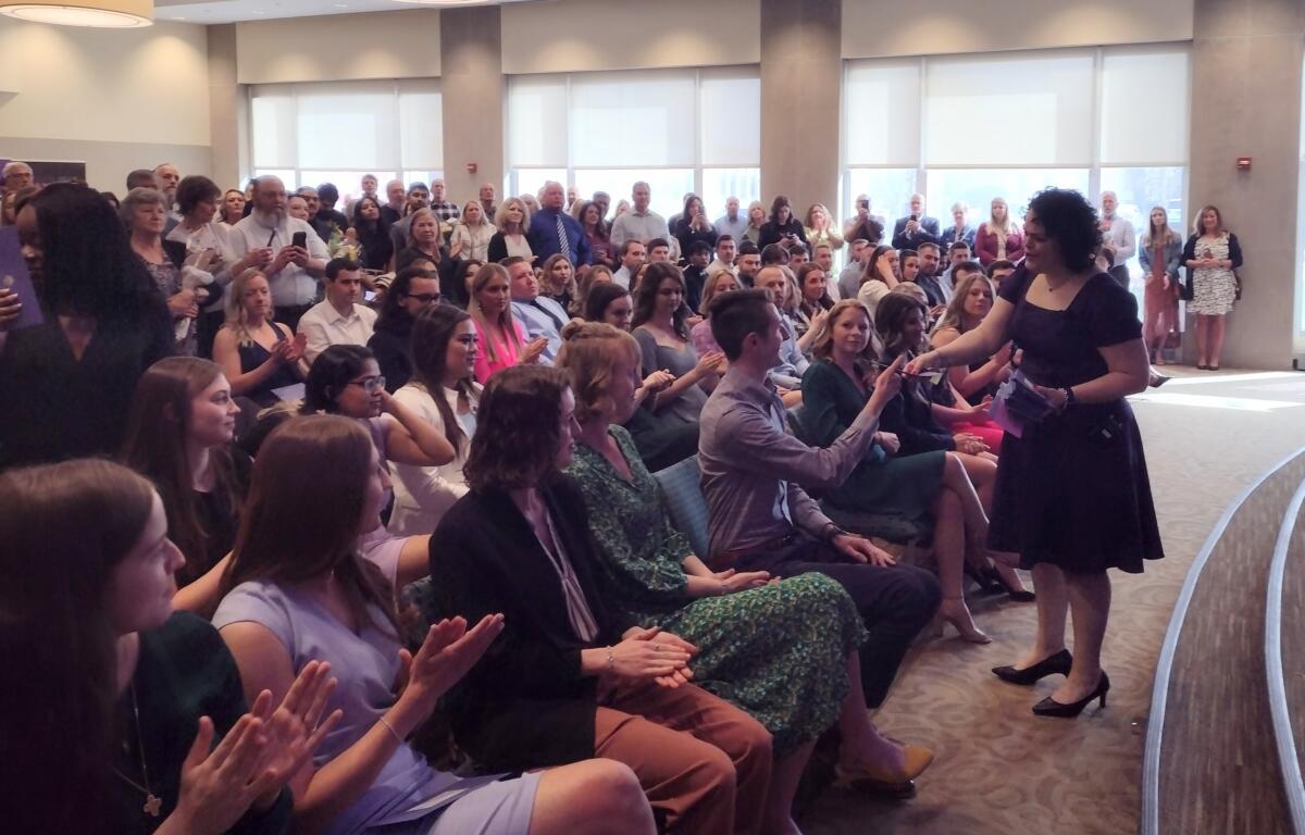 Dr. Haneme Idrizi, who is the Associate Dean for Student Affairs and Admissions at SIU Med, begins to hand out the purple envelopes that reveal a student's next destination.
