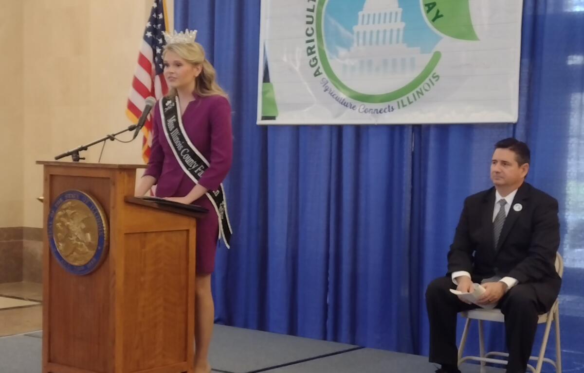IL County Fair Queen, Natalie Evans speaks to hundreds of Ag proponents while Il Ag Director, Jerry Costell II, looks on.