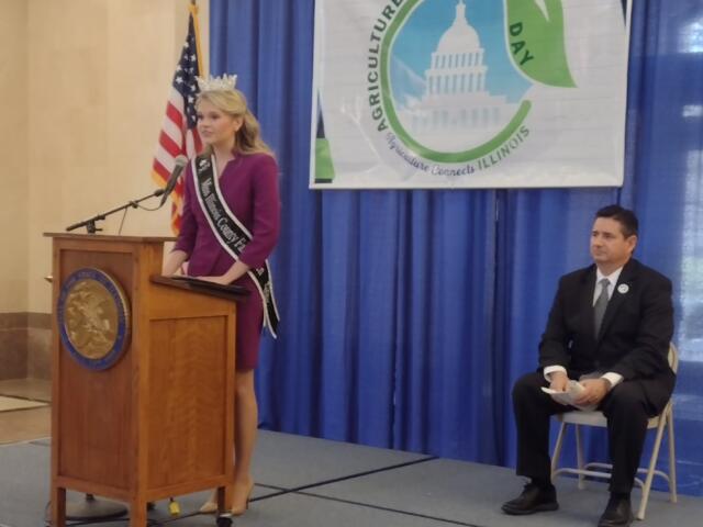 IL County Fair Queen, Natalie Evans speaks to hundreds of Ag proponents while Il Ag Director, Jerry Costell II, looks on.