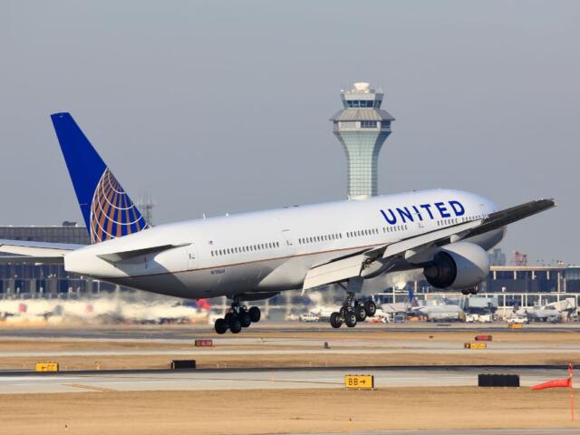 Chicago, Illinois, USA - March 19, 2017: United Airlines Boeing 777 passenger jet airplane arriving for a landing at O'Hare International Airport in Chicago, Illinois, USA.